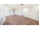 Open living area with ceiling fan, sliding glass doors, and wood-look flooring at 1051 Normandy Blvd, Holiday, FL 34691