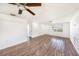 Living room featuring a ceiling fan, light colored walls, and wood-look flooring at 1051 Normandy Blvd, Holiday, FL 34691