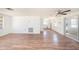 Spacious living room with ceiling fan, open to kitchen and sliding glass doors at 1051 Normandy Blvd, Holiday, FL 34691