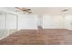 Spacious living room with wood-look flooring, ceiling fan, and sliding glass doors at 1051 Normandy Blvd, Holiday, FL 34691