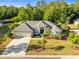 Expansive aerial view of a home with a well-maintained lawn and mature trees at 10726 Miracle Ln, New Port Richey, FL 34654