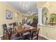 Dining room with hardwood floors, chandelier, and view into living spaces at 10726 Miracle Ln, New Port Richey, FL 34654