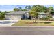Charming single-story home featuring a 2-car garage and well-manicured lawn at 10726 Miracle Ln, New Port Richey, FL 34654
