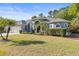 Well-maintained single-story home with lush green lawn and mature landscaping at 10726 Miracle Ln, New Port Richey, FL 34654
