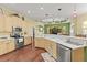 Spacious kitchen featuring stainless steel appliances, white countertops, and wood cabinets under a tray ceiling at 10726 Miracle Ln, New Port Richey, FL 34654
