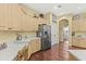 Expansive kitchen with light wood cabinets, stainless steel fridge, and a convenient desk area near the pantry at 10726 Miracle Ln, New Port Richey, FL 34654