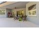 Covered patio with ceiling fan and comfortable seating area for relaxing or entertaining at 10726 Miracle Ln, New Port Richey, FL 34654