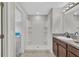 A bathroom features a walk-in shower with shelves and single vanity at 10936 Rainbow Pyrite Dr, Wimauma, FL 33598