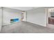Bright bedroom with soft gray carpeting, neutral walls, and a television set at 10936 Rainbow Pyrite Dr, Wimauma, FL 33598