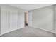 Neutral bedroom with grey carpet, closet and attached doorway at 10936 Rainbow Pyrite Dr, Wimauma, FL 33598
