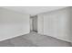 Spacious bedroom with soft gray carpeting and a double door closet for storage at 10936 Rainbow Pyrite Dr, Wimauma, FL 33598