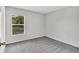 Cozy bedroom with a window view and plush carpeting for a comfortable living space at 10936 Rainbow Pyrite Dr, Wimauma, FL 33598