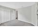 Carpeted bedroom with closet, en suite door and neutral walls at 10936 Rainbow Pyrite Dr, Wimauma, FL 33598