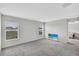 Neutral bedroom boasting soft carpet, large windows and television at 10936 Rainbow Pyrite Dr, Wimauma, FL 33598