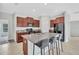 Modern kitchen with granite countertops, stainless steel appliances, and a center island with seating at 10936 Rainbow Pyrite Dr, Wimauma, FL 33598