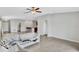 A bright living room featuring neutral paint, tile floors, and an open design to the kitchen at 10936 Rainbow Pyrite Dr, Wimauma, FL 33598