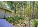 View of the home with a wooded backyard at 1120 Country Ln, Lutz, FL 33558