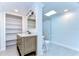 Bathroom featuring a marble vanity, built-in shelves, and a skylight at 1120 Country Ln, Lutz, FL 33558