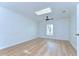Bedroom featuring wood floors, wainscoting, and a skylight at 1120 Country Ln, Lutz, FL 33558