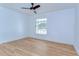 Bedroom featuring wood floors and a window with natural light at 1120 Country Ln, Lutz, FL 33558