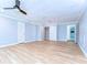 Spacious bedroom with wood floors, ceiling fan, and ensuite bath at 1120 Country Ln, Lutz, FL 33558