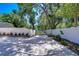 Long driveway and a white fence offer privacy and curb appeal to the property at 1120 Country Ln, Lutz, FL 33558