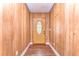 Welcoming entryway with wood-paneled walls and decorative door at 1120 Country Ln, Lutz, FL 33558