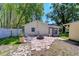 Outdoor area with brick firepit, well-maintained yard, mature trees, and exterior view of the back house at 1120 Country Ln, Lutz, FL 33558