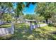 Charming home featuring a gated entrance, lush greenery, and a well-maintained lawn at 1120 Country Ln, Lutz, FL 33558
