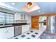Bright kitchen with skylight features white cabinets, stainless appliances, and unique tile flooring at 1120 Country Ln, Lutz, FL 33558