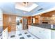 Bright kitchen with white cabinets, stainless appliances, stone fireplace, and wood accents at 1120 Country Ln, Lutz, FL 33558