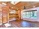 Bright living room with wood ceilings, built-in shelves, and a large window with view at 1120 Country Ln, Lutz, FL 33558