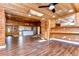 Spacious living room features wood floors, wood ceilings, a kitchen view, and natural light at 1120 Country Ln, Lutz, FL 33558