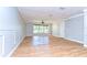 Light and airy living room featuring wood floors, crown molding, and a large window at 1120 Country Ln, Lutz, FL 33558