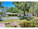 Home's pond featuring water lilies and lush greenery at 1120 Country Ln, Lutz, FL 33558