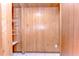 Wood paneled room with open shelving unit at 1120 Country Ln, Lutz, FL 33558