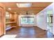 Bright sun room with wood details, neutral walls, tile flooring, and large windows to the yard at 1120 Country Ln, Lutz, FL 33558