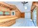 Bright sun room features a tile floor, natural wood, a ceiling fan and sliding glass door to outside at 1120 Country Ln, Lutz, FL 33558
