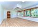 Sunroom featuring wooden trim, ample natural light, and a doorway to another room at 1120 Country Ln, Lutz, FL 33558