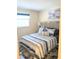 Cozy bedroom featuring a queen bed, decorative pillows and blue, white and gray bedding at 120 S Church Ave # 207, Tampa, FL 33609