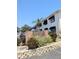 Kingston Court signage surrounded by mature trees and black window awnings under a clear blue sky at 120 S Church Ave # 207, Tampa, FL 33609