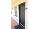 A welcoming entrance to unit 207 featuring a modern door, stylish exterior lighting, and a convenient peephole at 120 S Church Ave # 207, Tampa, FL 33609