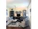 Cozy living room features a soft sofa, chair, entertainment center, and stylish decor for a comfortable space at 120 S Church Ave # 207, Tampa, FL 33609