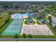 Aerial view of community amenities including a pool, clubhouse, tennis court, and playground for Gathering enjoyment at 12123 Ledbury Commons Dr, Gibsonton, FL 33534