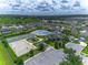 Aerial view showcasing the community amenities, including the pool, clubhouse, tennis court, and basketball court at 12123 Ledbury Commons Dr, Gibsonton, FL 33534