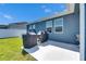 Backyard featuring patio area with covered grills, fenced yard, and well-maintained lawn at 12123 Ledbury Commons Dr, Gibsonton, FL 33534