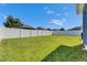 Wide shot of large, well-manicured fenced backyard with lush lawn and landscaping at 12123 Ledbury Commons Dr, Gibsonton, FL 33534