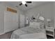 Charming bedroom with wood look floors, ceiling fan, and an open door leading to another room at 12123 Ledbury Commons Dr, Gibsonton, FL 33534