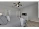 Bedroom featuring a ceiling fan, a dresser with a TV, and a bathroom and closet entrance at 12123 Ledbury Commons Dr, Gibsonton, FL 33534