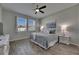 Comfortable bedroom featuring wood-look floors, neutral paint, ceiling fan, and bright, natural light at 12123 Ledbury Commons Dr, Gibsonton, FL 33534